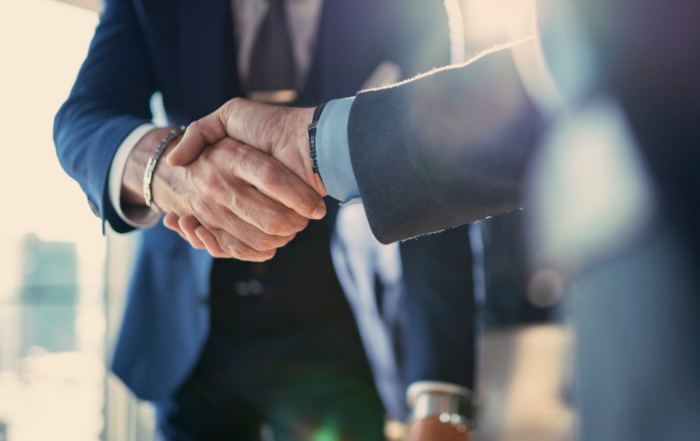 A closeup of a handshake between two businessmen signifying the importance of a partnership with a Managed Service Provider.