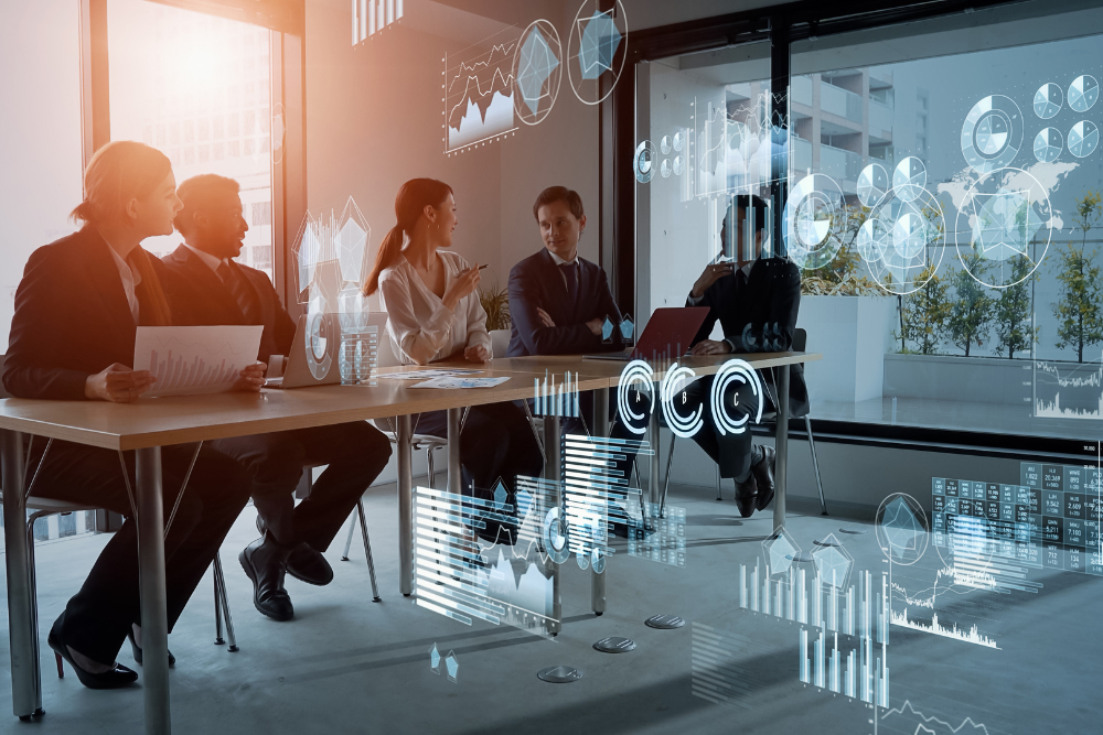 A group of office workers sits in a conference room with analytics icons overlaid on top of them as a conceptual image for cybersecurity services.